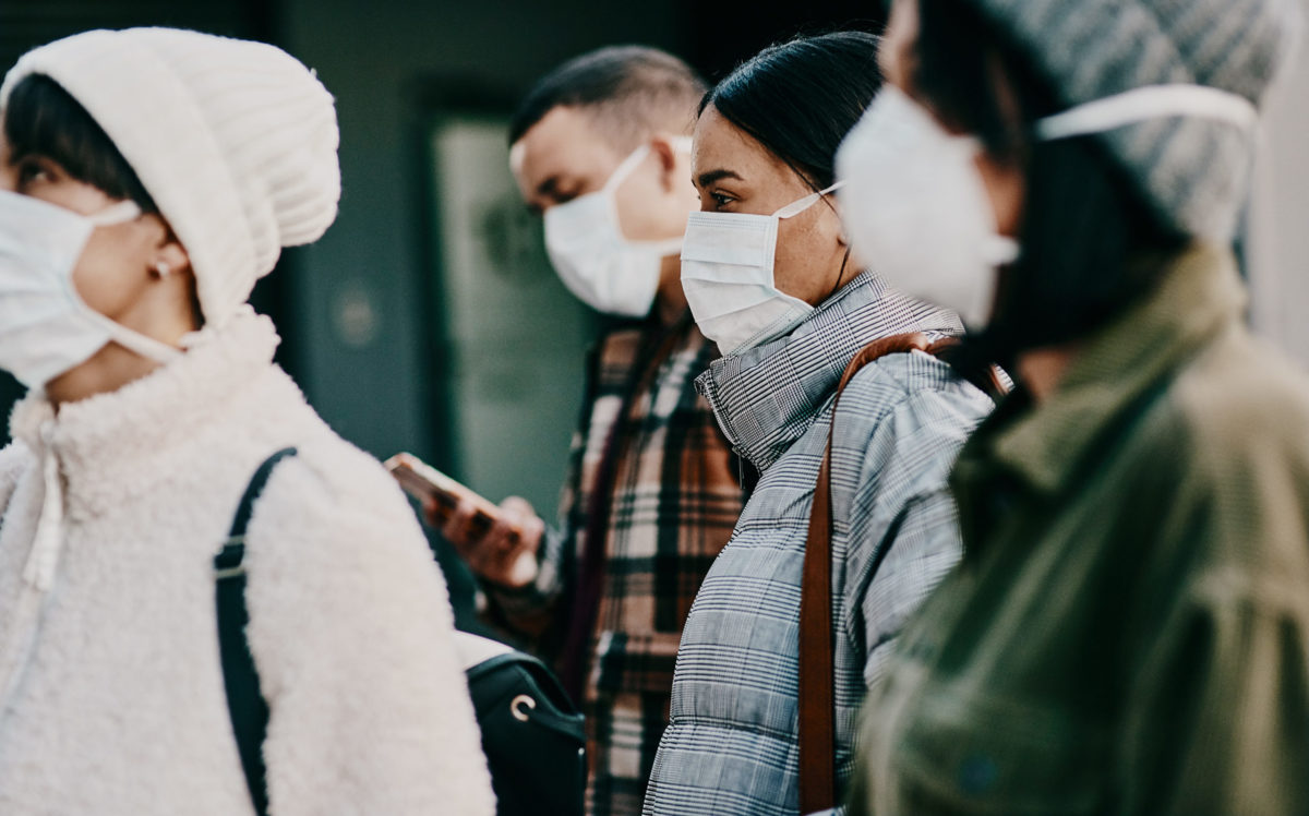 Photo of a crowd with people wearing face masks